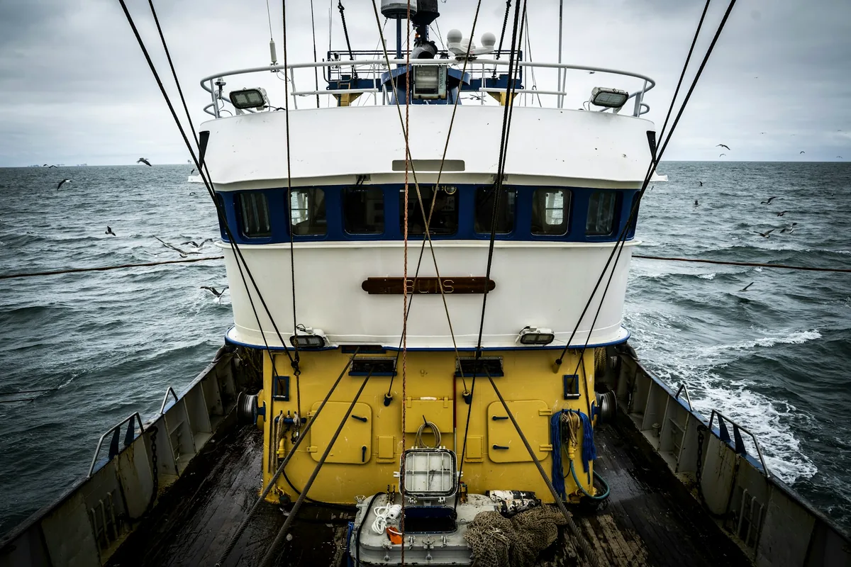 A fishing trawler working in an open grey sea