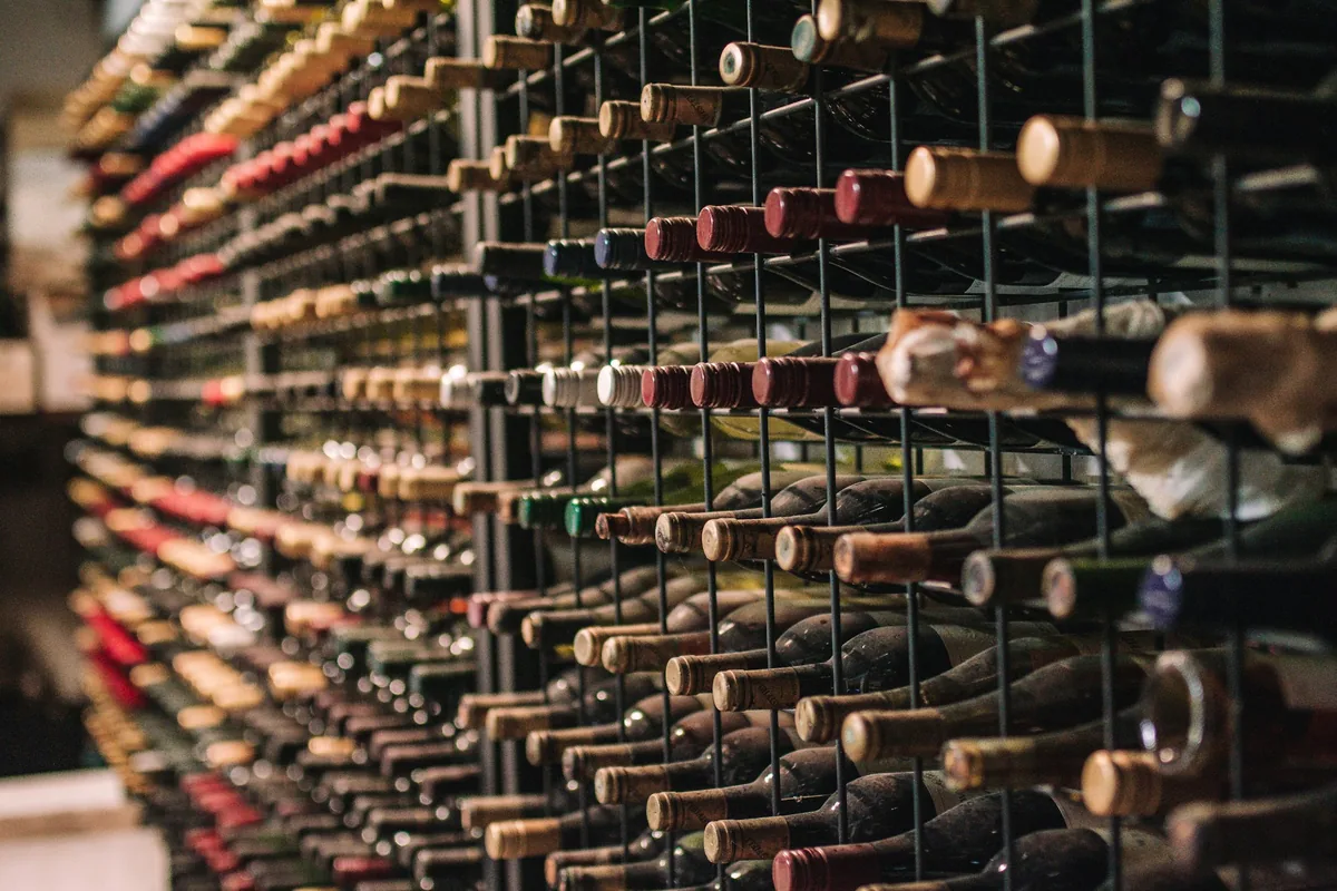 A tall wall of individual bottle racks seen at an angle
