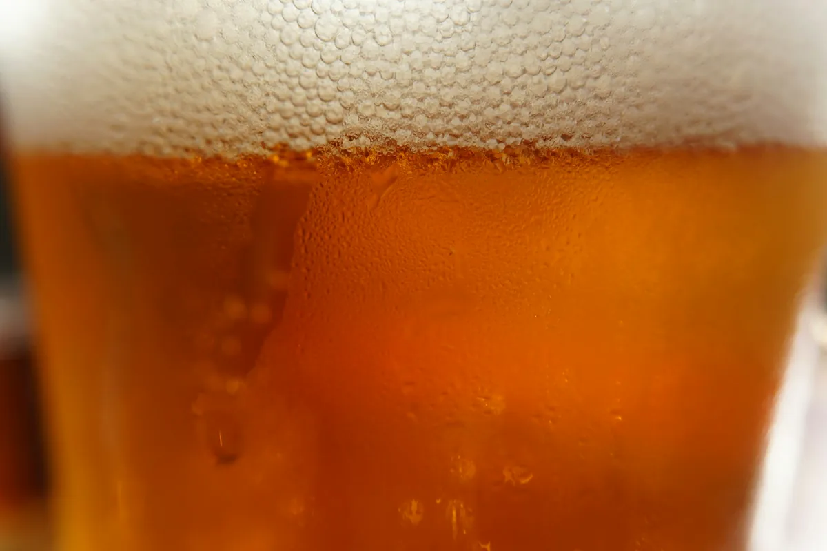 A glass of amber beer topped with a fine dense head