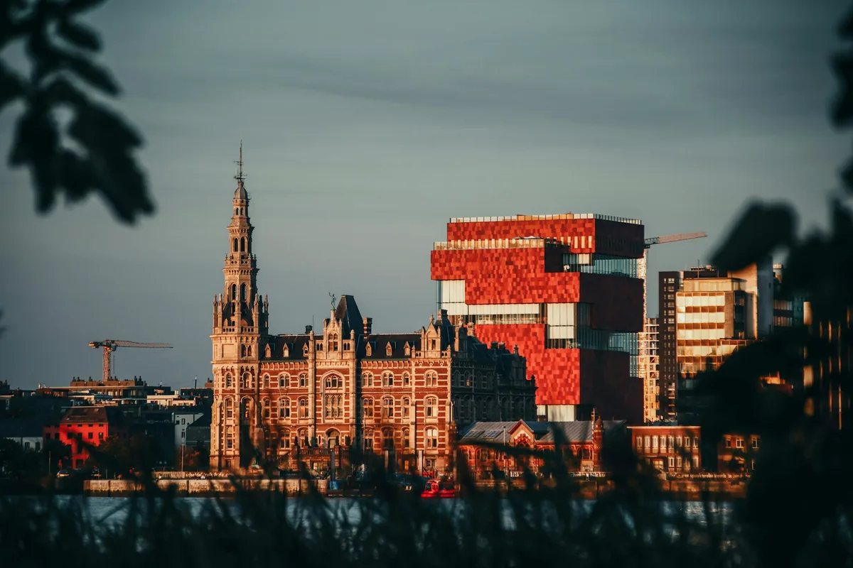 A view across Antwerp rooftops and towers in late evening light