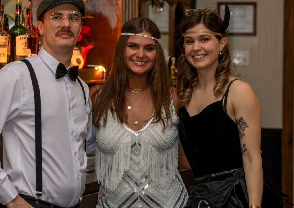 Three members of the Meyboom Brasserie bar team in nineteen-twenties dress on New Year's Eve