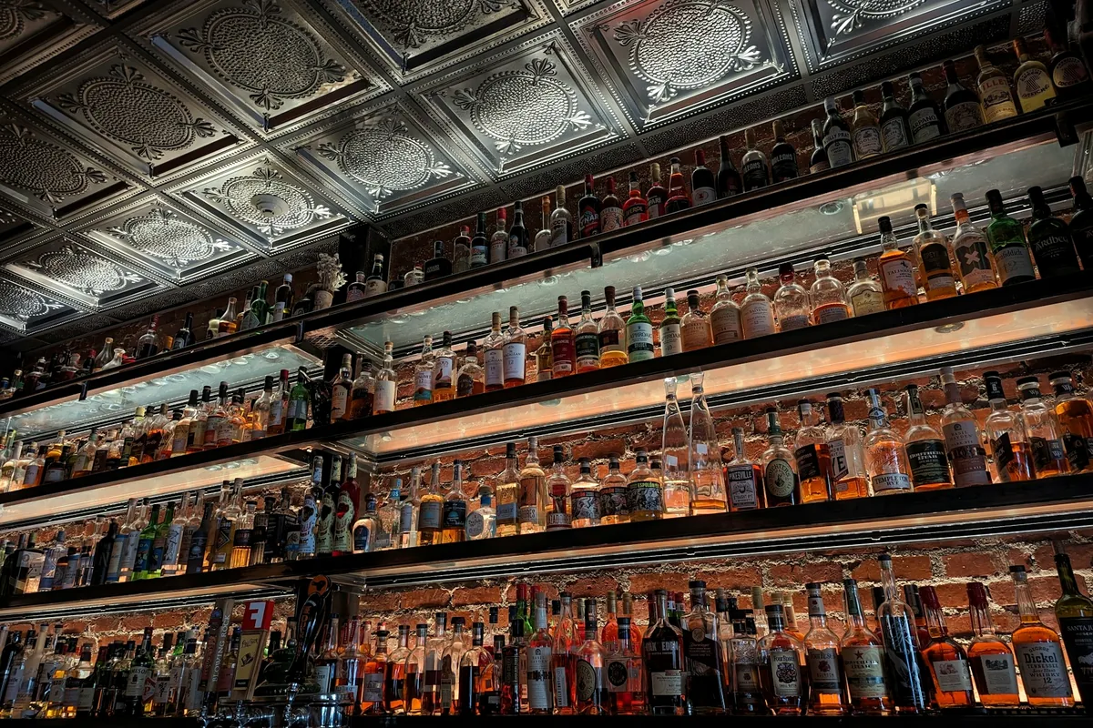 A back bar lined with rows of liquor bottles
