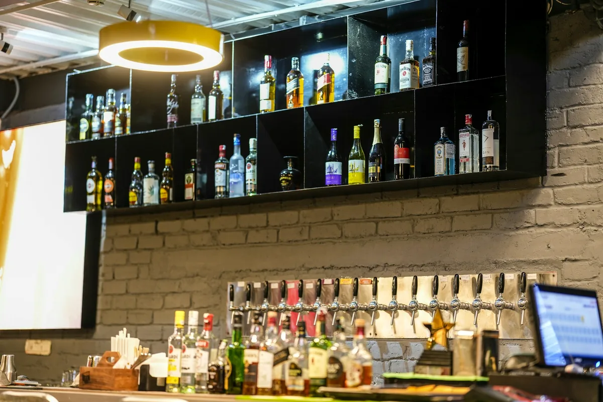Shelves of spirit bottles behind a bar counter