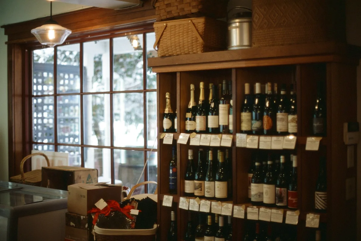 Racks of bottles displayed along the wall of a drinks shop