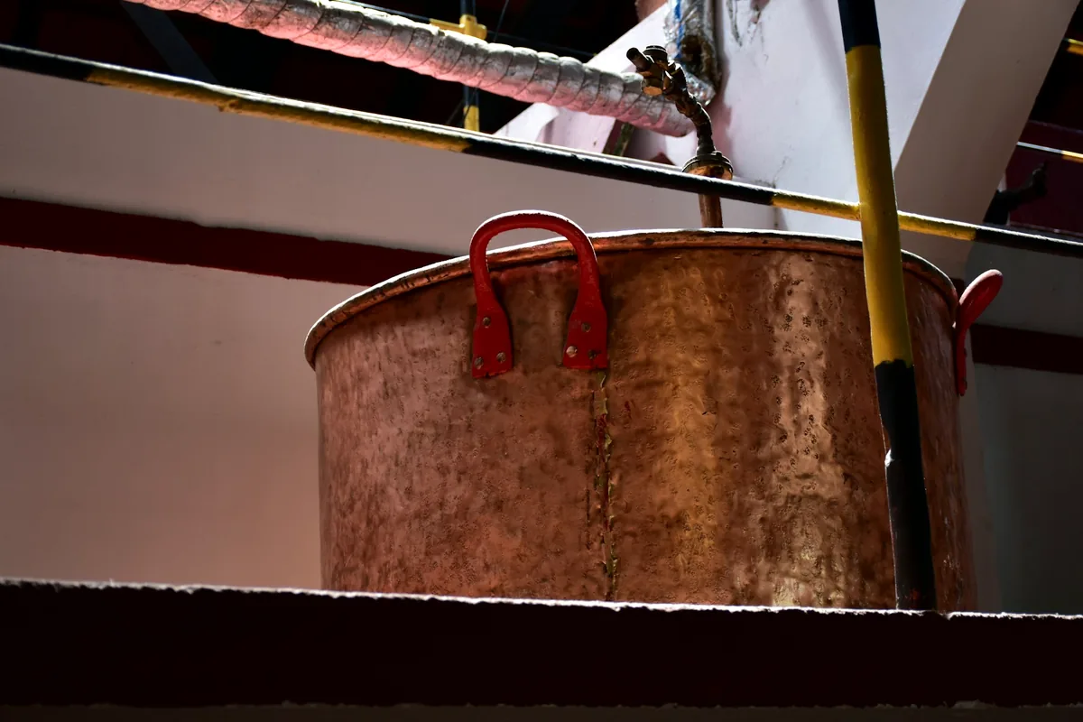 A copper brewing kettle in a brewery