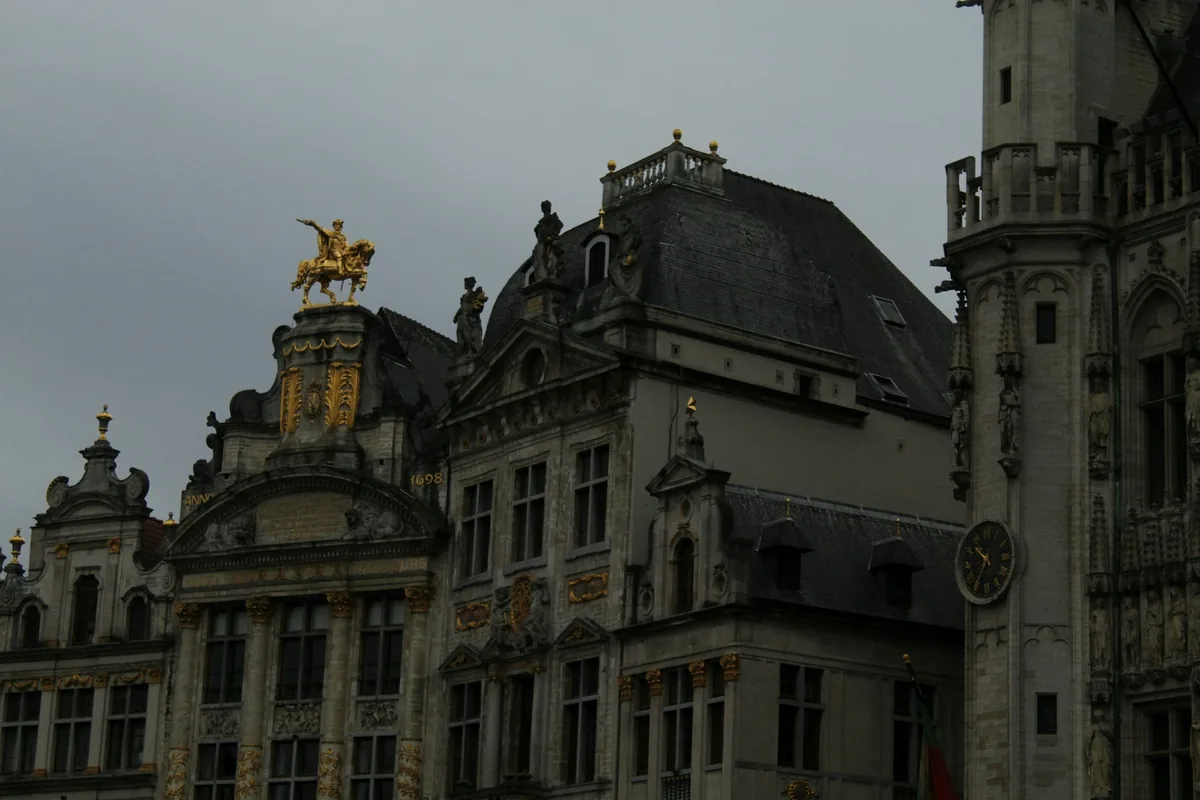 Ornate stone and gilded rooftops of historic buildings in central Brussels