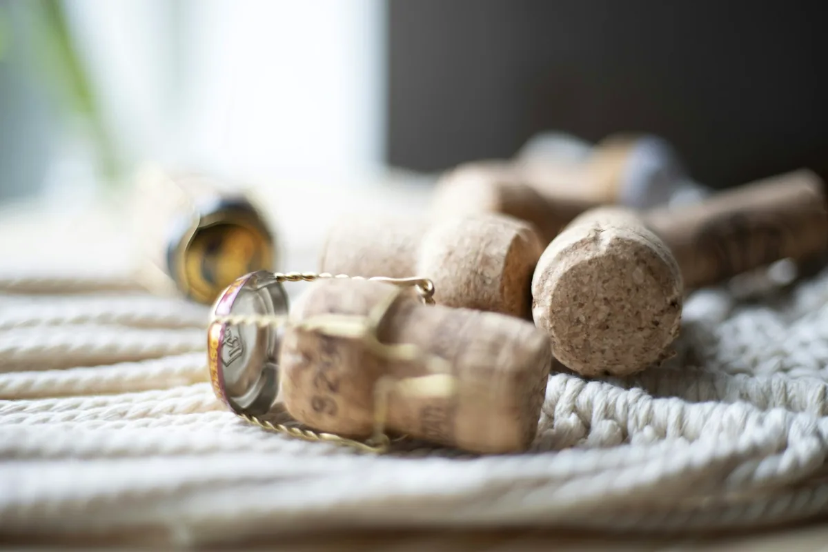 A group of used corks resting on a pale table