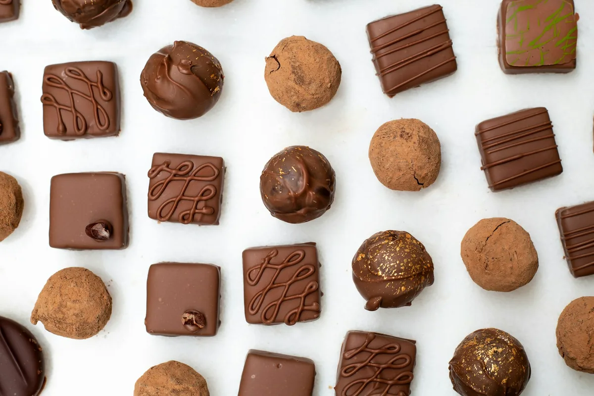 Three decorated chocolate bars with nuts and patterned surfaces