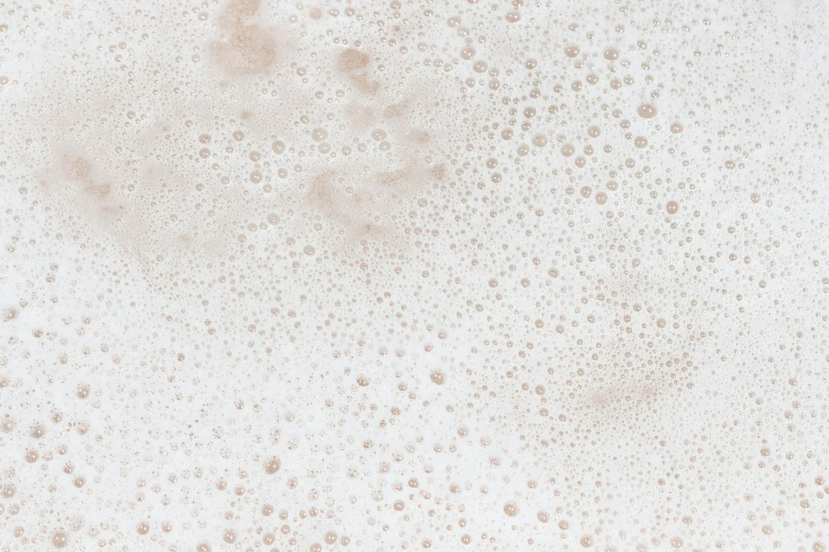 An extreme close-up of the fine bubbles in a beer foam