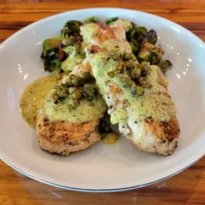 Pan-seared chicken with dijon creme, fried capers and Brussels sprouts