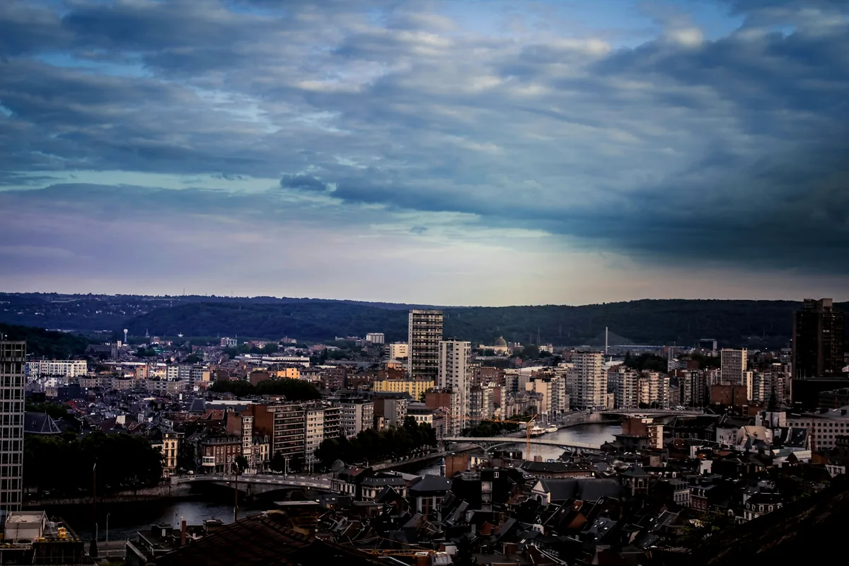 The city of Liege seen across its valley under a broad sky