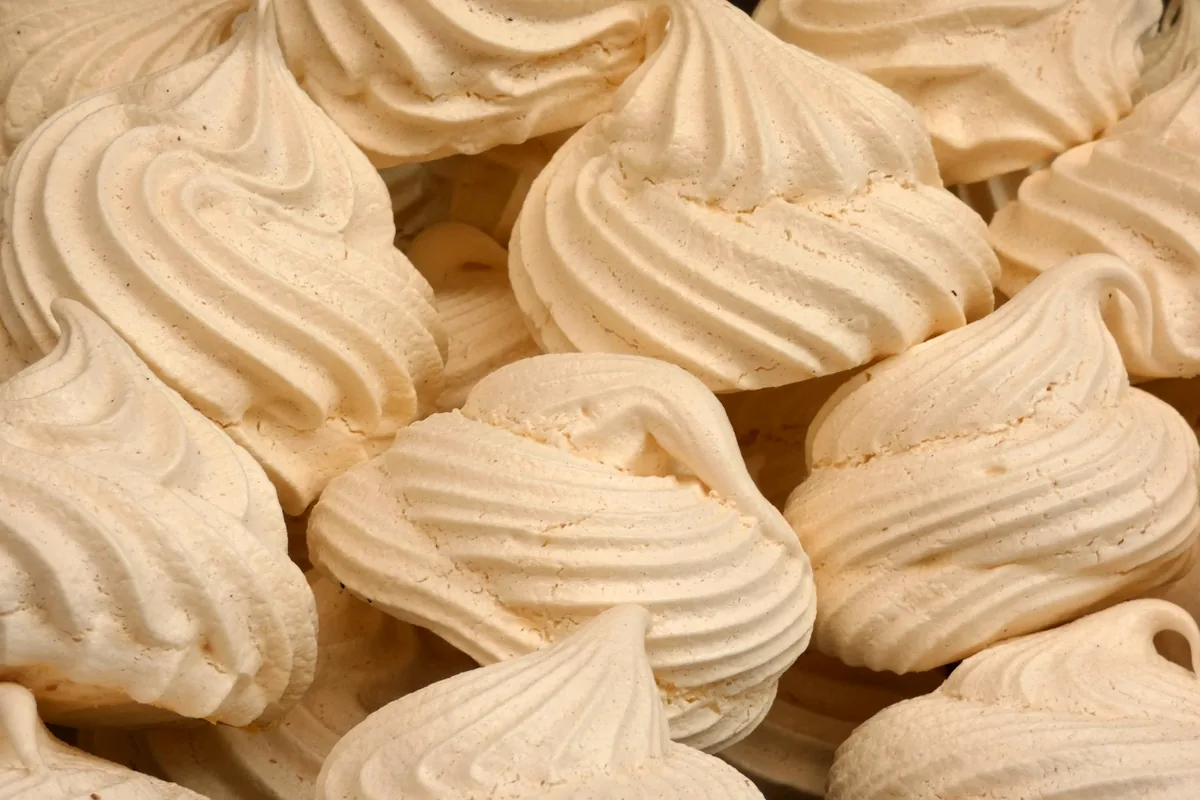 A pile of small white meringue cookies