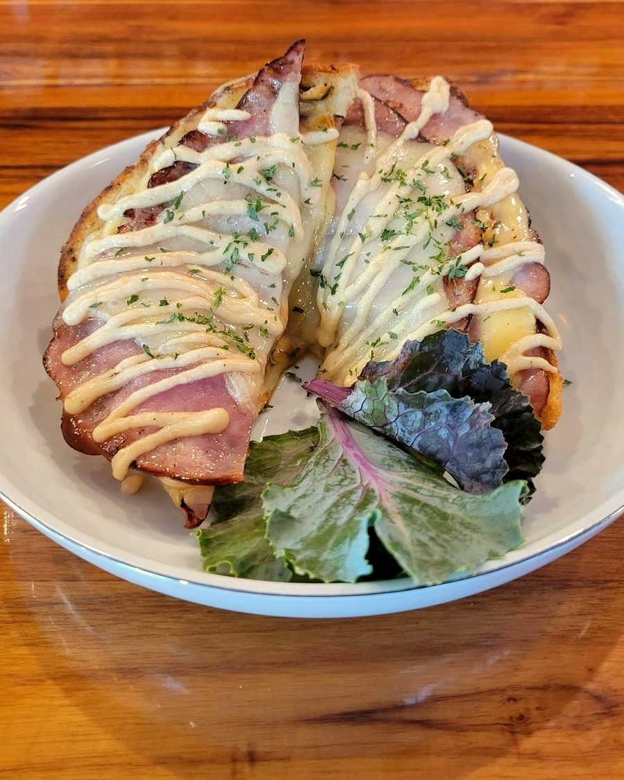 Croque monsieur — grilled ham, gouda and gruyere with Mornay sauce, served with greens
