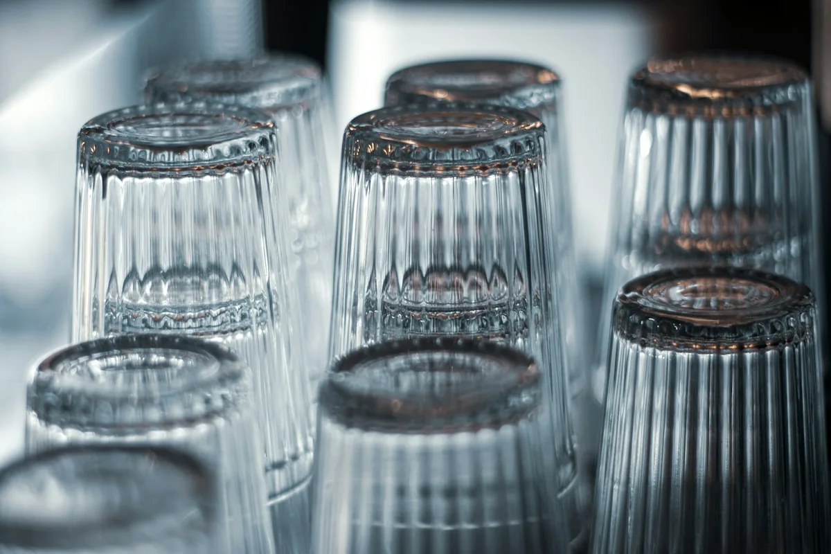 Upturned ribbed drinking glasses in rows
